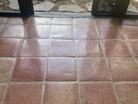 Before: Dull, worn Mexican Saltillo tile floor before and a rich glossy finish after stripping and resealing